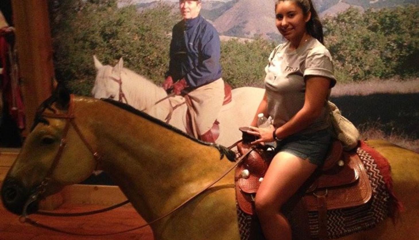 Girl Riding a Fake Horse