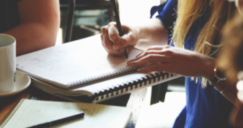 Student writing in a notebook