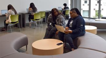 A financial aid technician assisting a student with their financial aid application