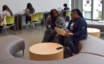 A financial aid technician assisting a student with their financial aid application