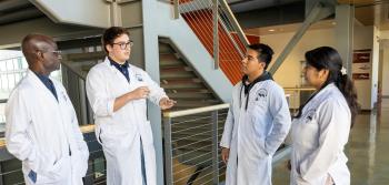 Three male and one female students are discussing the Biomanufacturing major