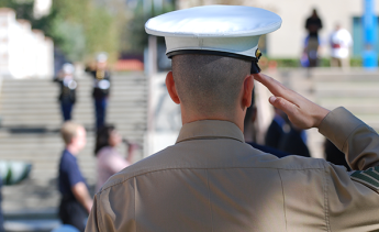 A young Marine saluting the United States flag