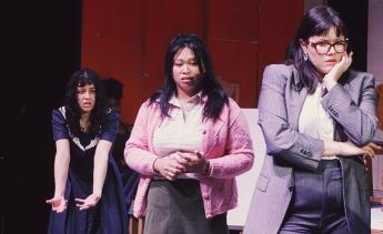Student actors rehearsing Three Sisters on stage.