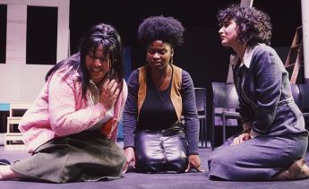 Student actors rehearsing Three Sisters on stage.