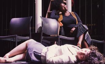 Student actors rehearsing Three Sisters on stage.