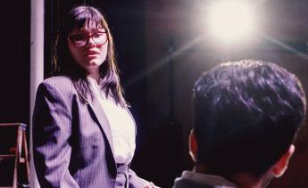 Student actors rehearsing Three Sisters on stage.