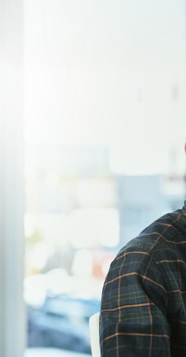 Young latino man at a help desk